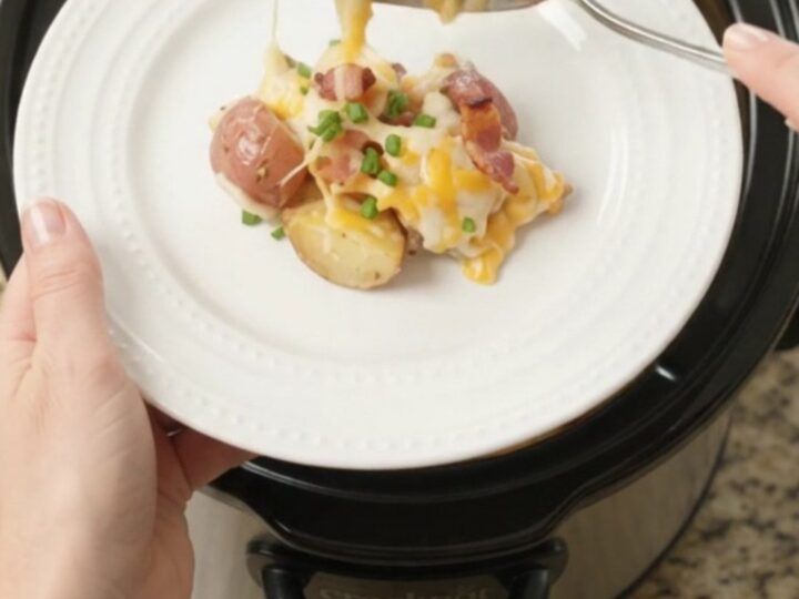 Bubbling slow cooker full of cheesy red potatoes and bacon