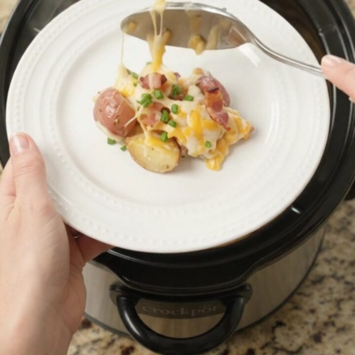 Bubbling slow cooker full of cheesy red potatoes and bacon