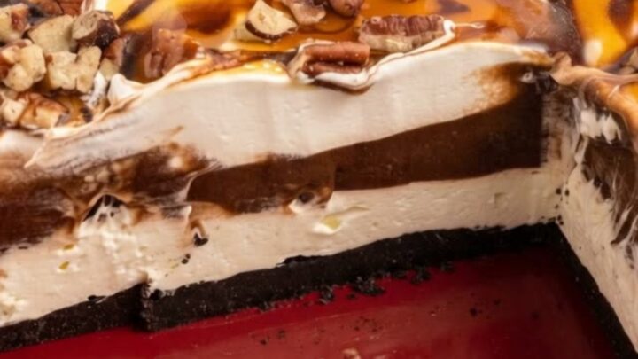 A decadent slice of layered sugar-free turtle lush dessert with glistening chocolate and caramel drizzles and toasted pecans