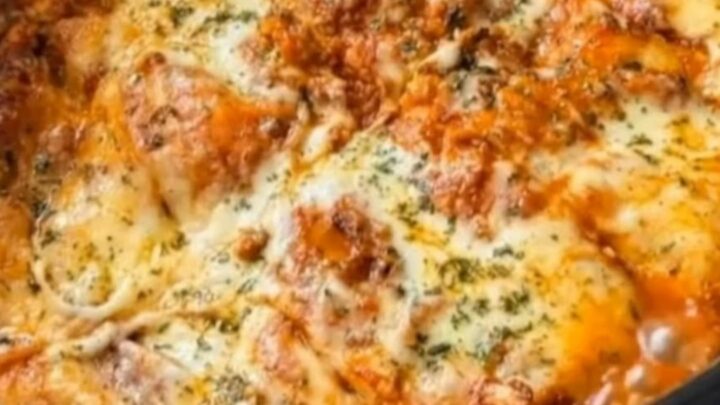 A deep slice of slow cooker lasagna being lifted with a spatula, creating a long