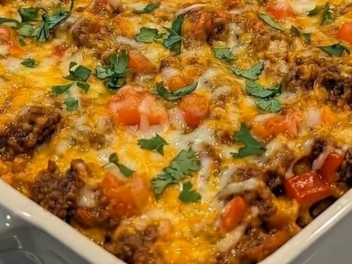 A warm slice of Beef Fiesta Tortilla Casserole being lifted with a long, gooey cheese pull.