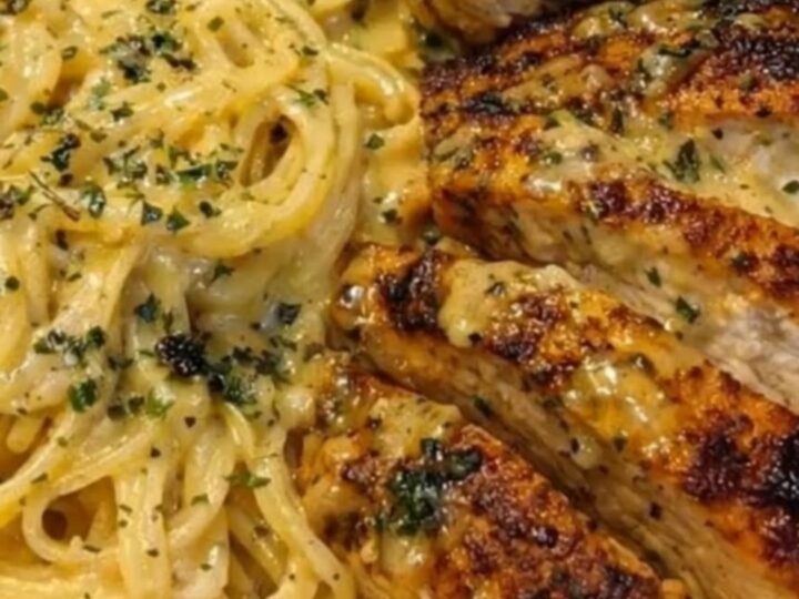 A shallow bowl filled with creamy garlic butter chicken spaghetti and golden seared chicken strips.