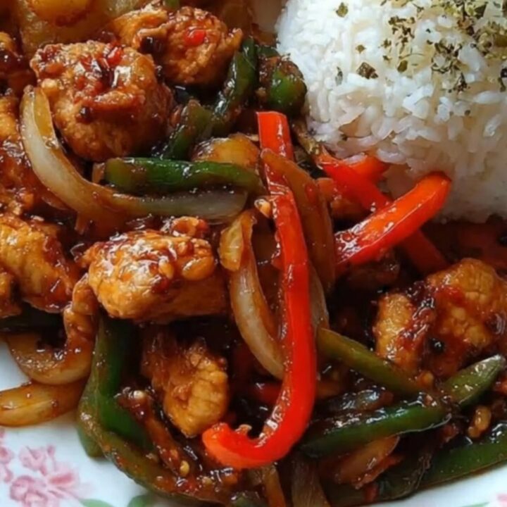 A delicious sweet and spicy chicken stir-fry served with roasted potato wedges and white rice.
