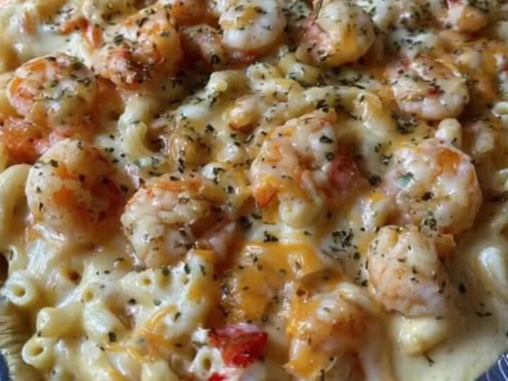 A steaming scoop of seafood mac and cheese with a dramatic cheese pull, loaded with shrimp and macaroni.