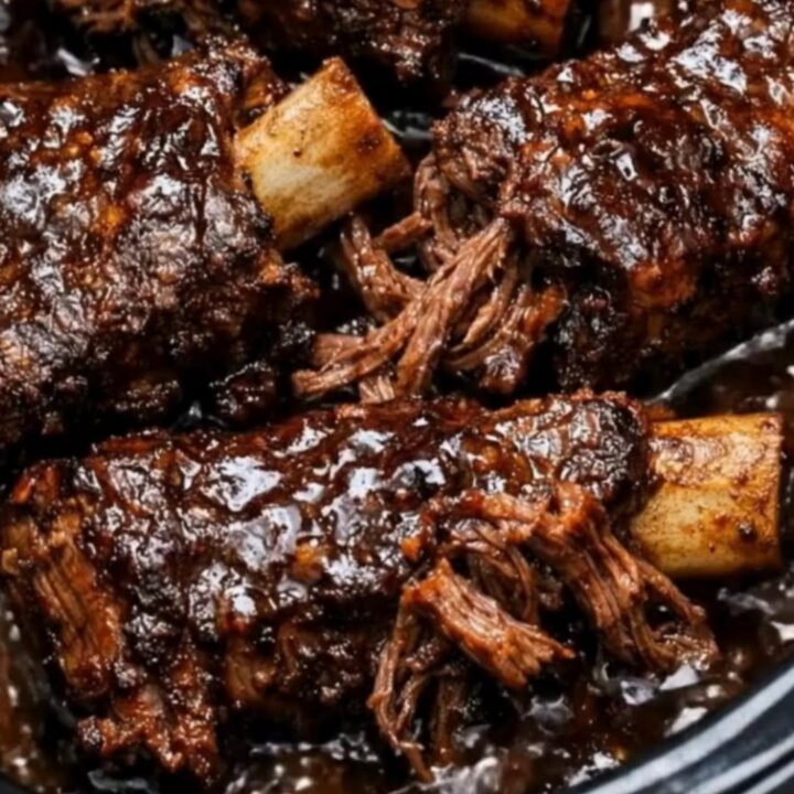 Succulent stout braised short ribs served on a plate with a thick, dark sauce.