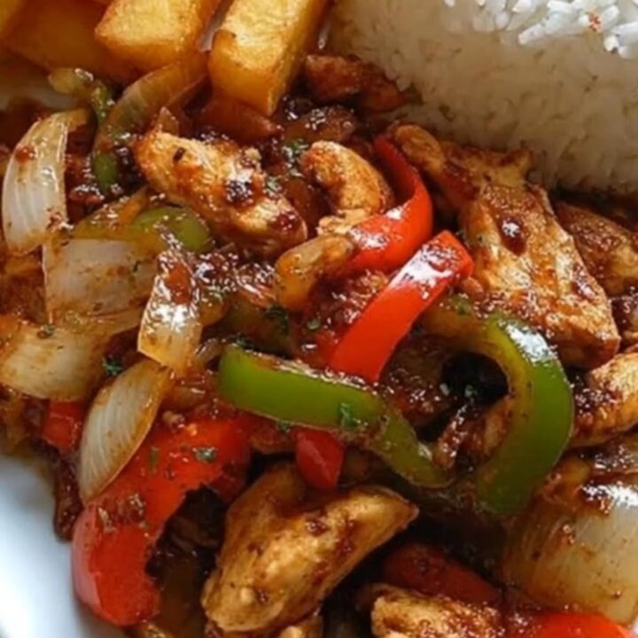 A plate featuring chicken stir-fry with peppers, crispy golden potato wedges, and a neat dome of white rice.