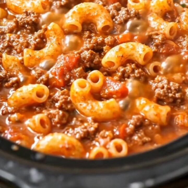 A steaming, hearty bowl of beef and macaroni in a rich tomato sauce.