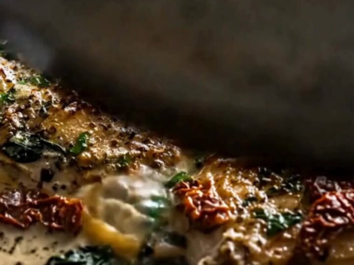 A juicy, slow-cooked chicken thigh covered in a creamy garlic Parmesan sauce with sun-dried tomatoes and spinach.