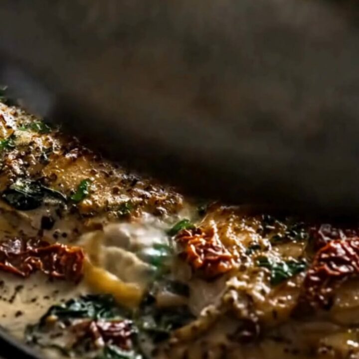 A juicy, slow-cooked chicken thigh covered in a creamy garlic Parmesan sauce with sun-dried tomatoes and spinach.
