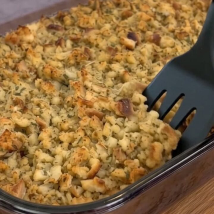 A golden-brown creamy chicken and stuffing casserole in a glass baking dish.