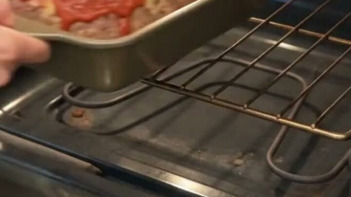 Juicy Italian meatloaf slice with a glossy tomato glaze served on a clean white dinner plate.