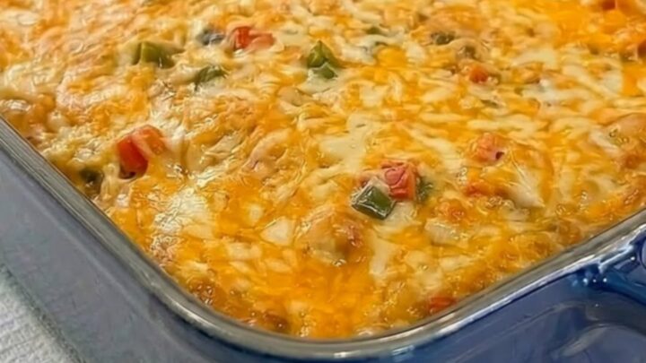 A steamy square of King Ranch chicken casserole being lifted from a blue dish.