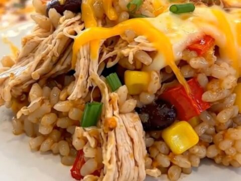 A cheesy southwest chicken casserole in a white baking dish with melted cheese and visible chicken and beans.