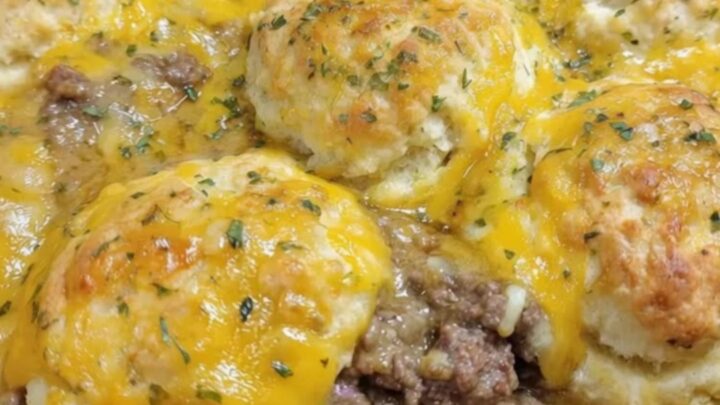 A golden-brown Cheddar Bay Hamburger Casserole in a sizzling cast-iron skillet garnished with parsley.