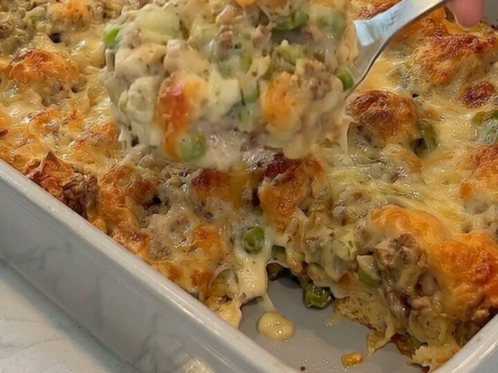 A golden-brown bubble up Philly cheese steak casserole in a grey ceramic dish.