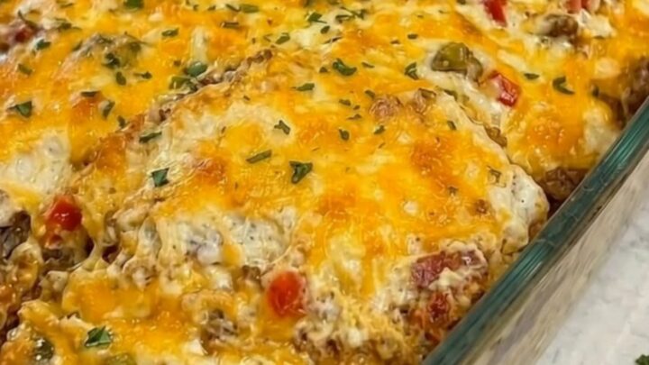 A warm, golden-brown Cattle Drive Casserole in a glass dish with melted cheese.