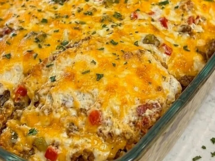 A warm, golden-brown Cattle Drive Casserole in a glass dish with melted cheese.