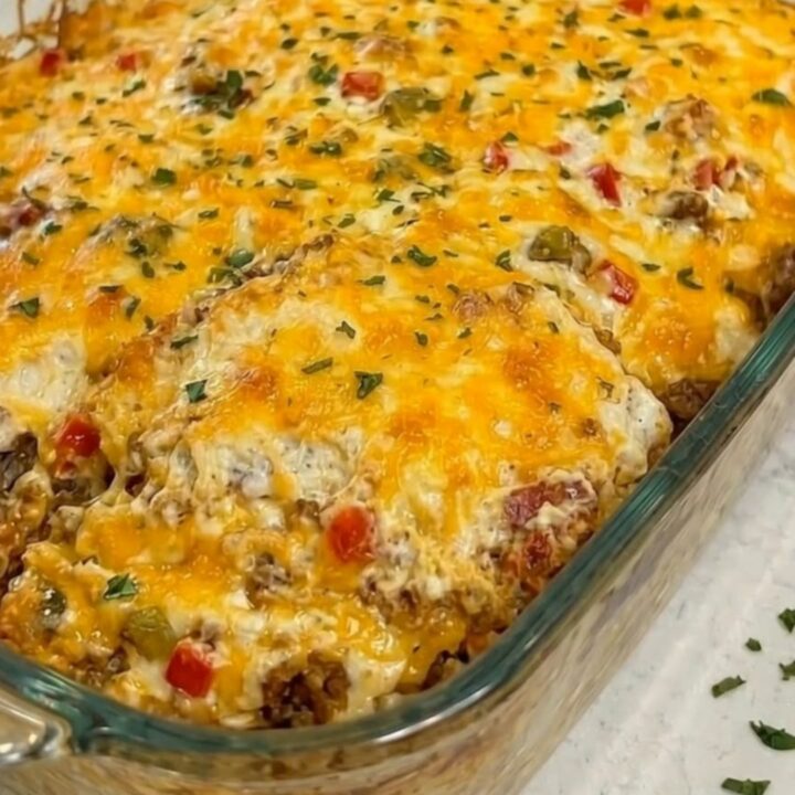 A warm, golden-brown Cattle Drive Casserole in a glass dish with melted cheese.