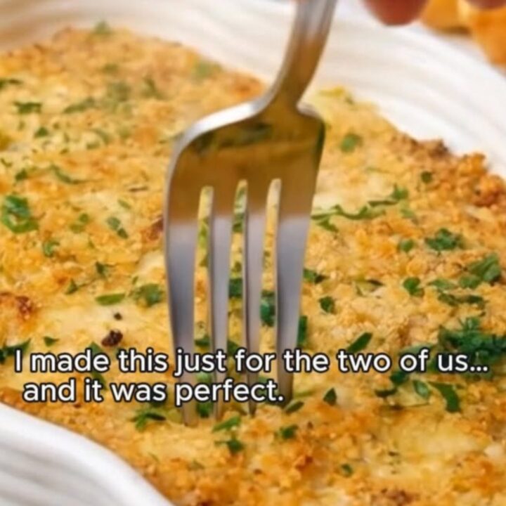 Golden panko-crusted chicken cordon bleu casserole bubbling in a fluted white dish.