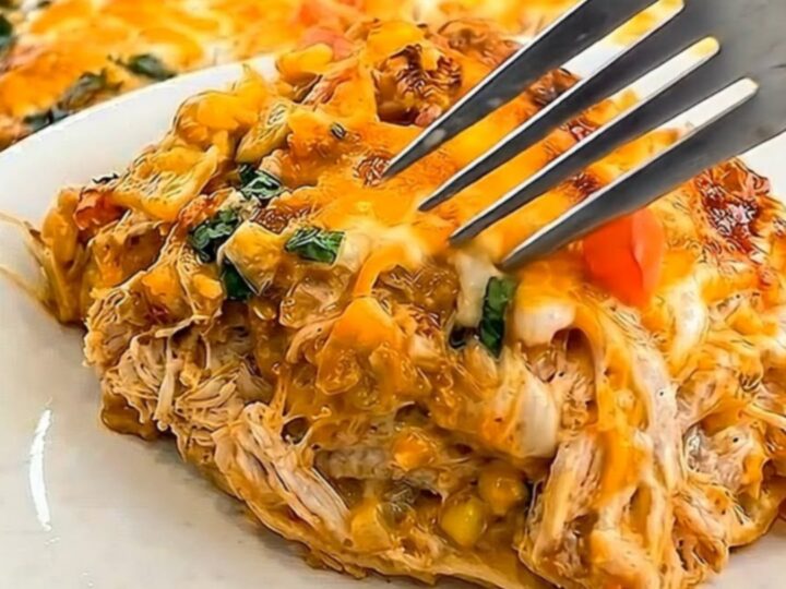 A golden, bubbly King Ranch Chicken Casserole in a baking dish with a visible cheese pull.