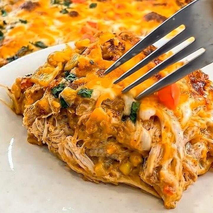 A golden, bubbly King Ranch Chicken Casserole in a baking dish with a visible cheese pull.