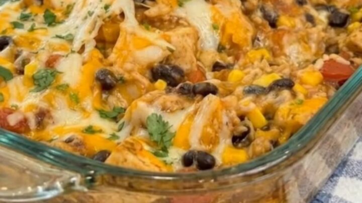 A golden-brown cheesy Mexican chicken casserole in a glass baking dish, fresh from the oven.