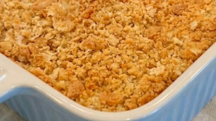 A golden-brown, bubbling creamy Ritz chicken casserole in a light blue baking dish.