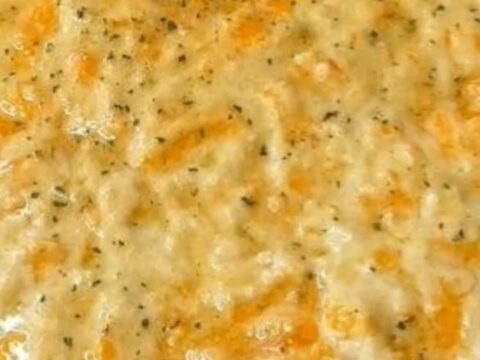 A steaming Sloppy Joe Casserole in a baking dish with a golden, cheesy biscuit crust on top.