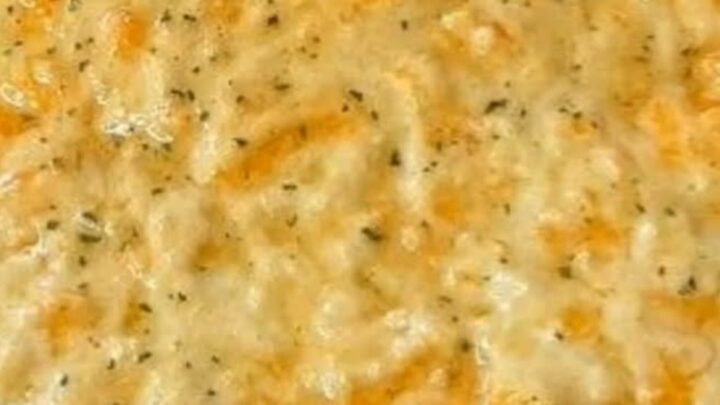A steaming Sloppy Joe Casserole in a baking dish with a golden, cheesy biscuit crust on top.
