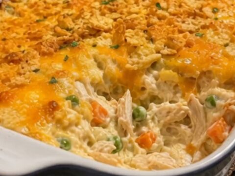 A warm, golden-brown Chicken Gloria Casserole in a ceramic baking dish on a kitchen counter.