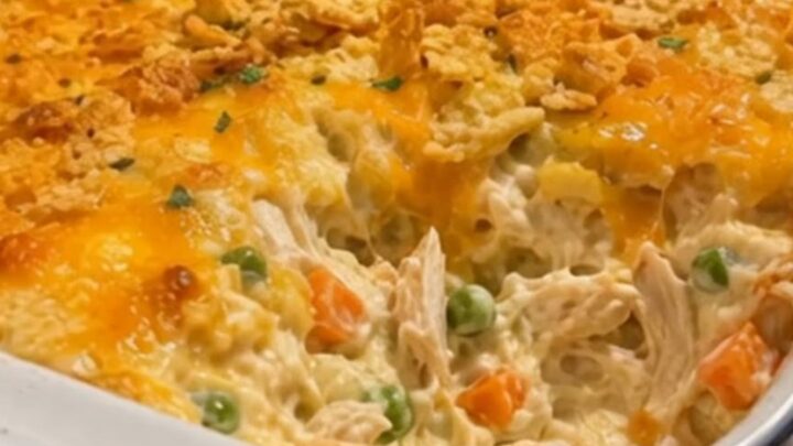 A warm, golden-brown Chicken Gloria Casserole in a ceramic baking dish on a kitchen counter.