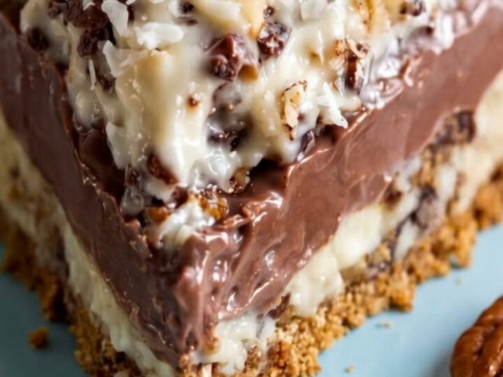 A slice of sugar-free German chocolate pie on a white plate with visible chocolate filling and toasted coconut.