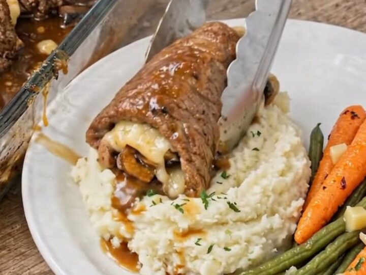 A juicy beef roll topped with melted mozzarella and mushrooms, served with gravy and mashed potatoes.