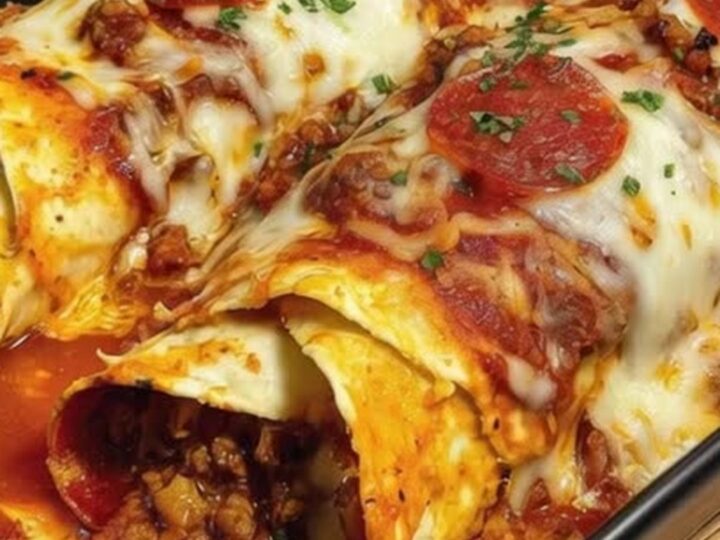 A spatula lifting a cheesy slice of ground beef pizza enchiladas with a dramatic mozzarella cheese pull.