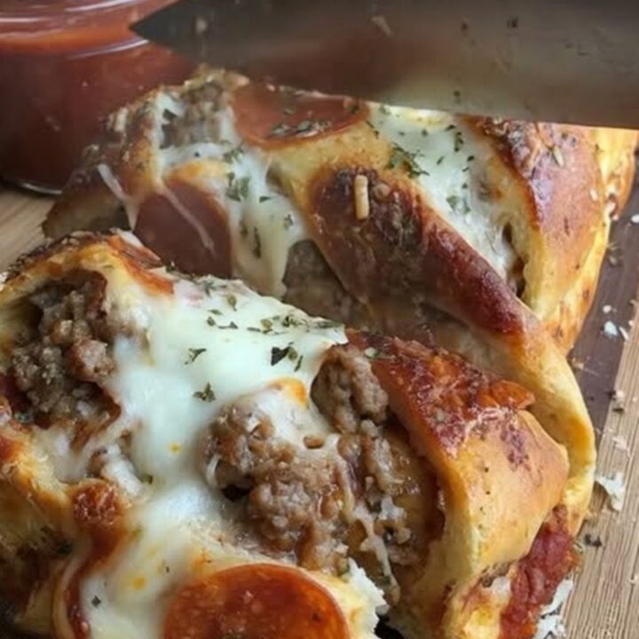 A golden, baked pizza bread loaf showing signs of a crispy, pepperoni-topped crust.