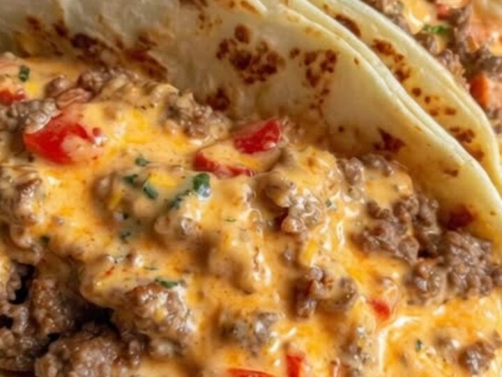 Stacked soft tacos overflowing with creamy cheesy Rotel beef filling on a serving platter