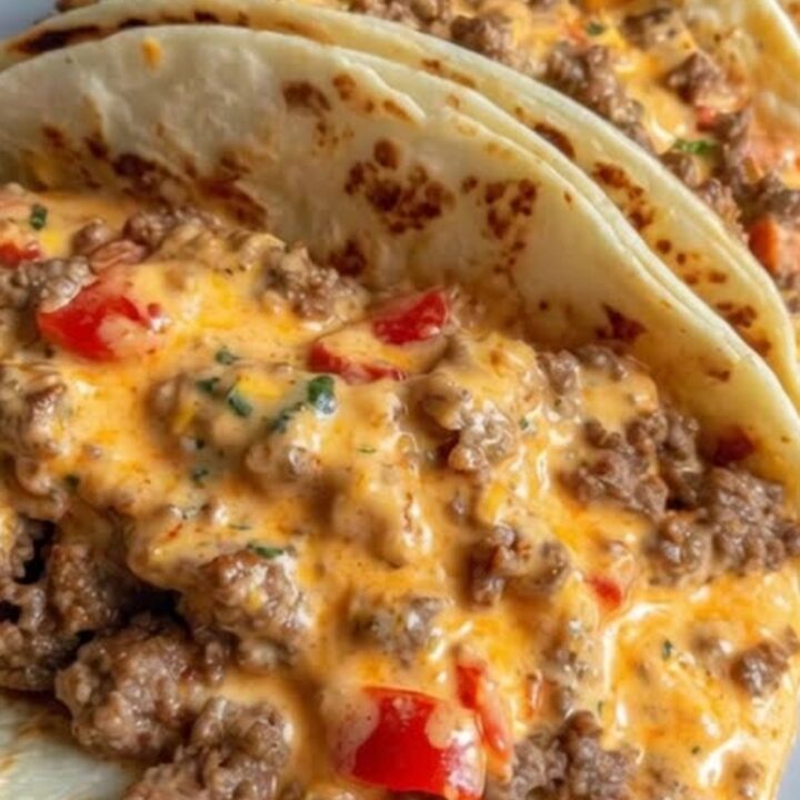 Stacked soft tacos overflowing with creamy cheesy Rotel beef filling on a serving platter
