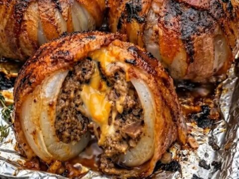 A plate featuring crispy bacon-wrapped onion bombs with melted cheese oozing from the center.
