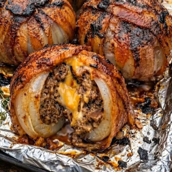 A plate featuring crispy bacon-wrapped onion bombs with melted cheese oozing from the center.