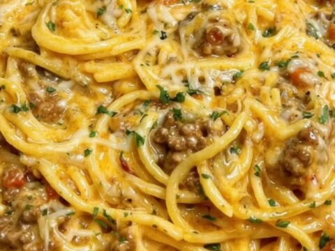 A steaming, rich portion of creamy Cajun beef spaghetti served in a ceramic bowl.