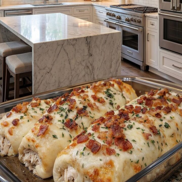 Golden breadstick bombs topped with melted mozzarella and parsley in a glass baking dish.