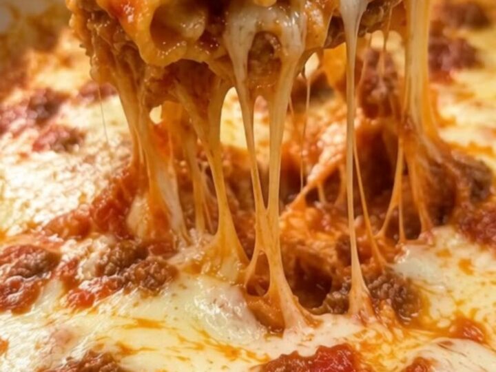 A steaming, bubbly skillet of one-pot lasagna topped with melted mozzarella cheese.