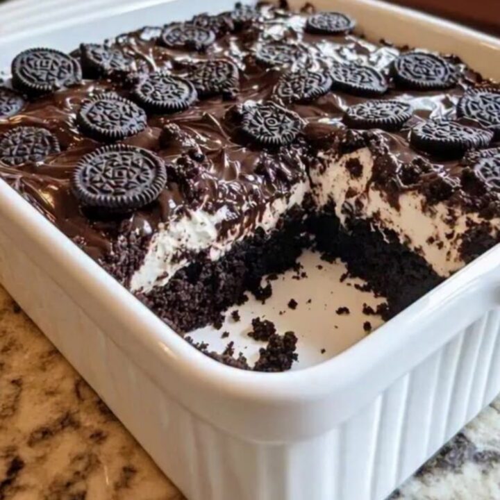 A slice of Oreo Earthquake Cake showing distinct layers of chocolate cake and gooey marshmallow cream.