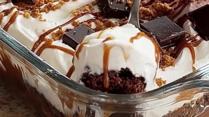 A close-up of a decadent chocolate caramel icebox cake with visible layers in a glass dish.