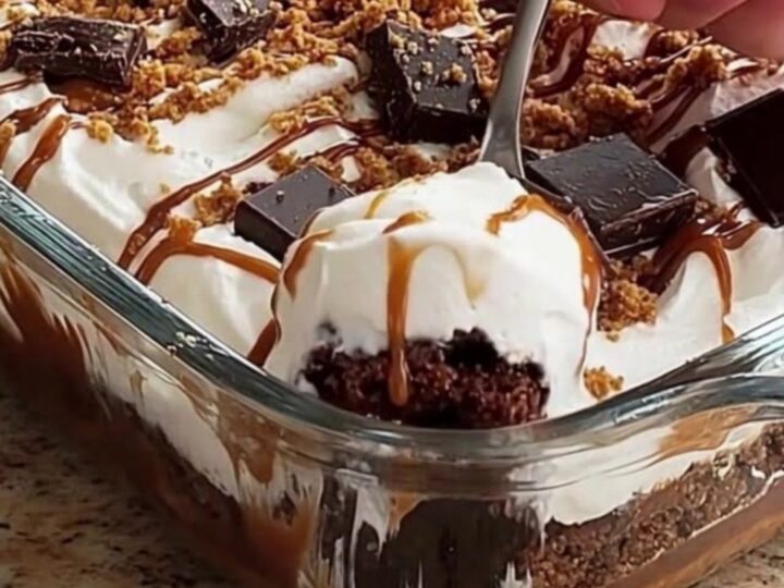 A close-up of a decadent chocolate caramel icebox cake with visible layers in a glass dish.