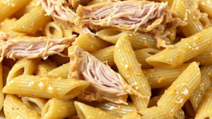A slow cooker filled with creamy Italian dressing chicken, cream cheese, and parmesan.