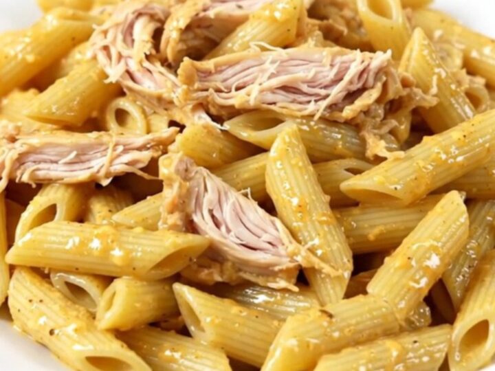 A slow cooker filled with creamy Italian dressing chicken, cream cheese, and parmesan.