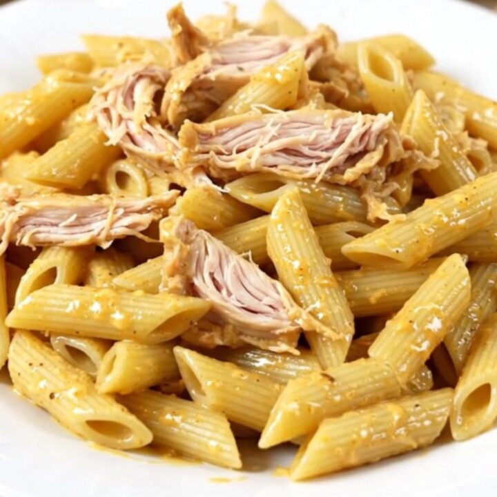 A slow cooker filled with creamy Italian dressing chicken, cream cheese, and parmesan.
