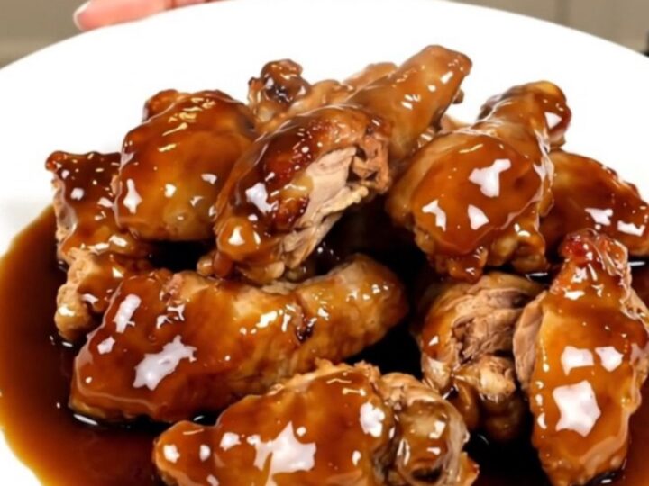 Slow cooker filled with cubed chicken breasts, pineapple chunks, brown sugar, and teriyaki sauce before cooking.