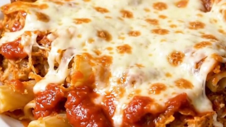 A steaming bowl of baked ziti with melted mozzarella cheese and savory Italian sausage crumbles.